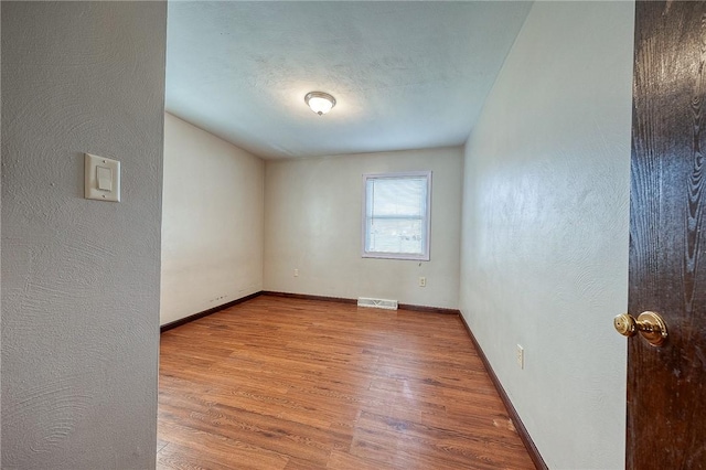 spare room with light wood-type flooring