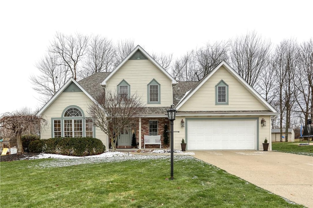 view of front of property with a front lawn and a garage