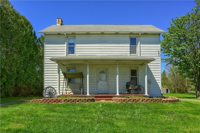 view of front facade with covered porch and a front yard