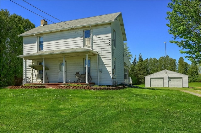 view of front of house with covered porch, a garage, an outdoor structure, and a front lawn