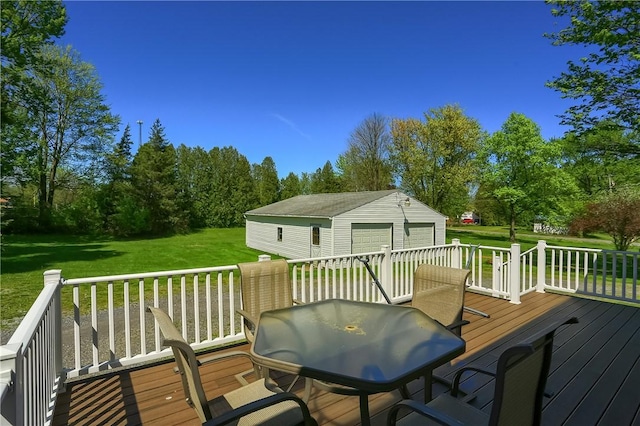 deck with a lawn, a garage, and an outdoor structure