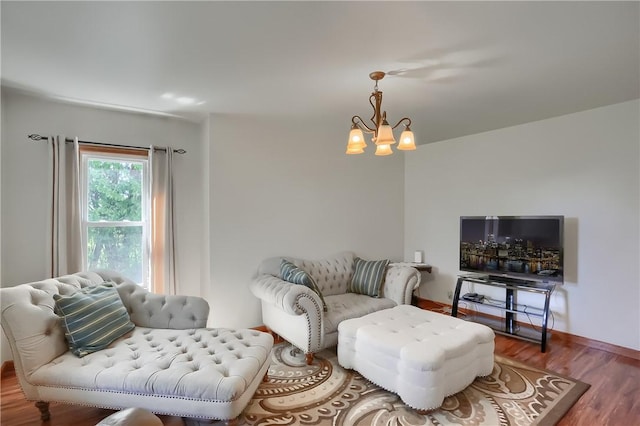 living room featuring a notable chandelier and wood-type flooring