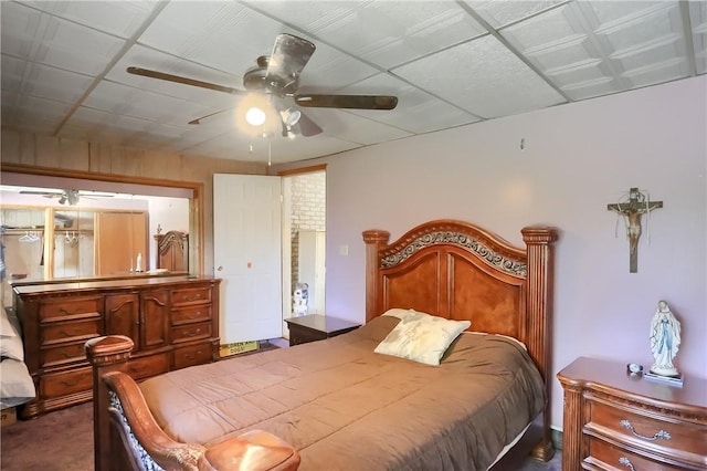 bedroom with ceiling fan and dark carpet