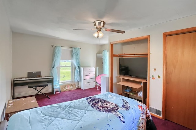 carpeted bedroom with ceiling fan and two closets