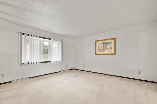 carpeted spare room with a textured ceiling