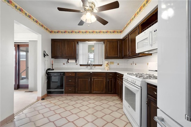 kitchen with white appliances, sink, a wealth of natural light, and tasteful backsplash