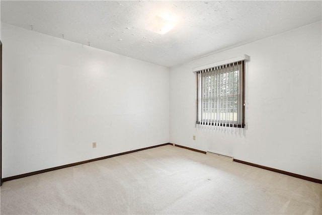 carpeted spare room featuring a textured ceiling