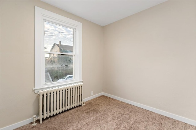 carpeted spare room with radiator heating unit