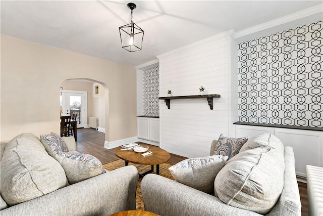 living room featuring dark hardwood / wood-style floors, radiator heating unit, and crown molding