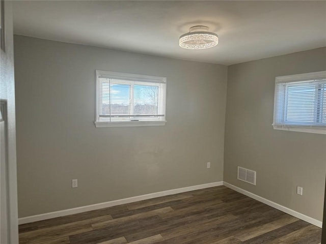 empty room with dark hardwood / wood-style floors