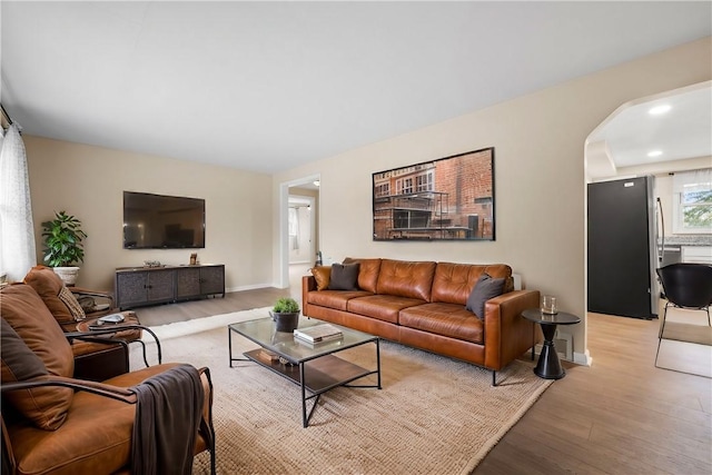 727 Scenery Dr, Elizabeth Twp/Boro, PA 15037 - living room featuring light wood finished floors, arched walkways, and recessed lighting