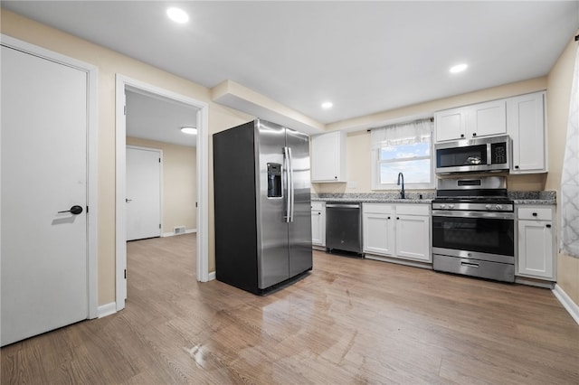 727 Scenery Dr, Elizabeth Twp/Boro, PA 15037 - kitchen featuring appliances with stainless steel finishes, light wood finished floors, white cabinetry, light stone counters, and recessed lighting