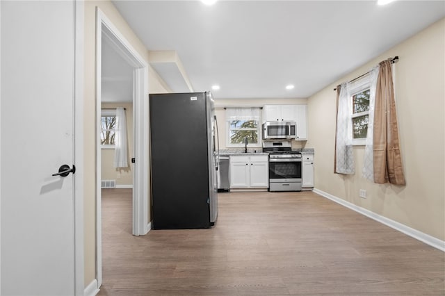 727 Scenery Dr, Elizabeth Twp/Boro, PA 15037 - kitchen featuring stainless steel appliances, white cabinetry, light wood finished floors, and recessed lighting