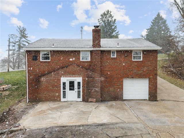 727 Scenery Dr, Elizabeth Twp/Boro, PA 15037 - rear view of property featuring a chimney, brick siding, driveway, an attached garage, and a shingled roof