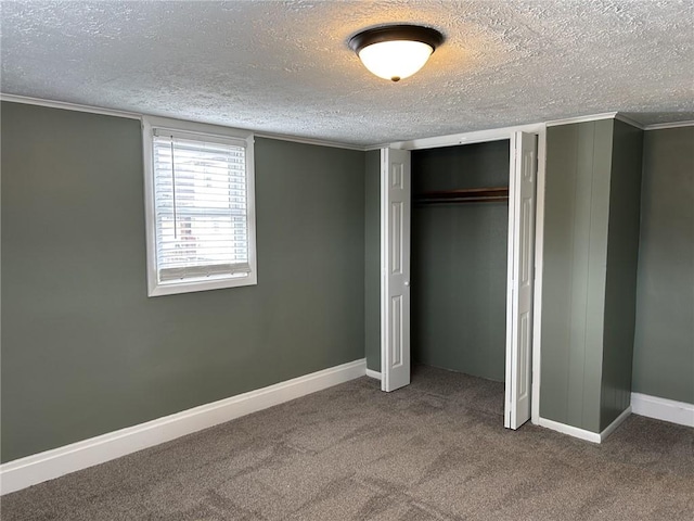 unfurnished bedroom with carpet floors and a textured ceiling