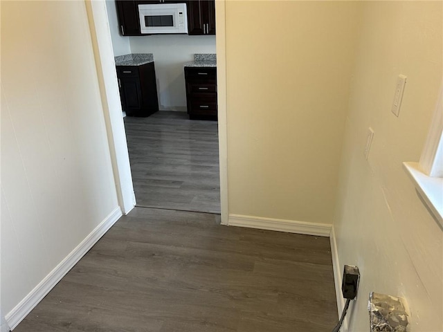 hallway with dark hardwood / wood-style floors