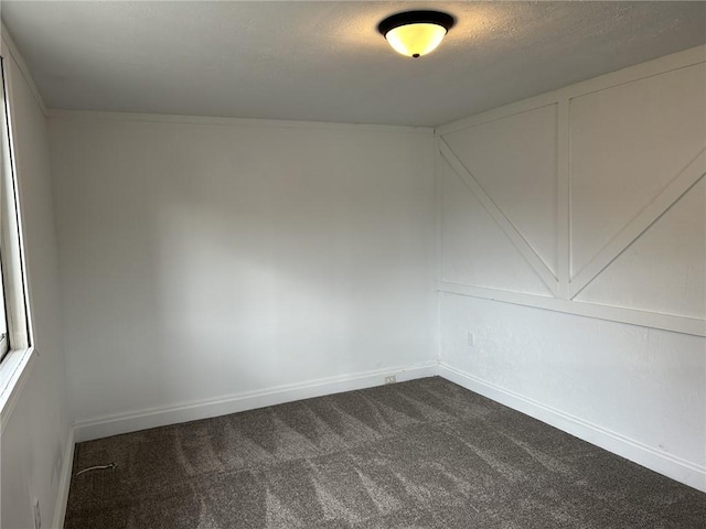 empty room featuring carpet and a textured ceiling