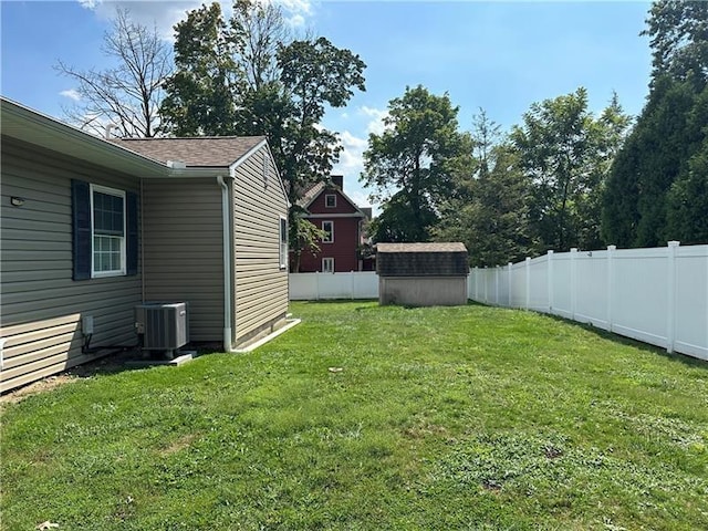 view of yard featuring central AC and a shed