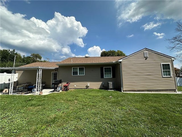 rear view of house featuring a yard and a patio area