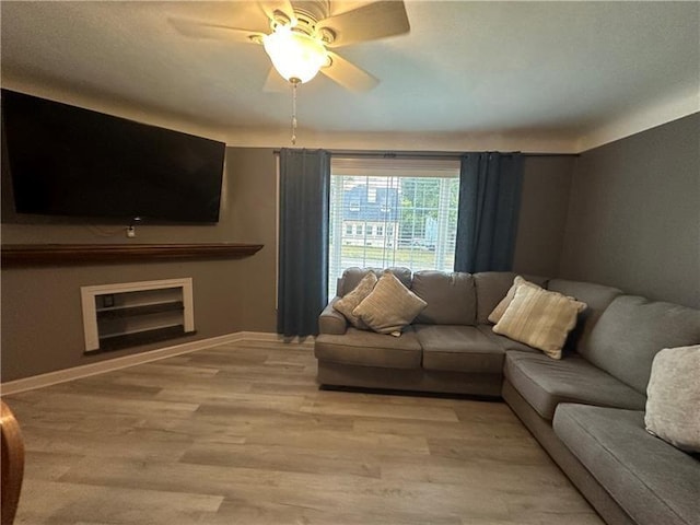 living room featuring ceiling fan and light hardwood / wood-style floors