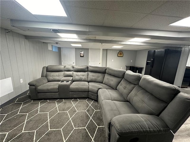 carpeted living room with a drop ceiling