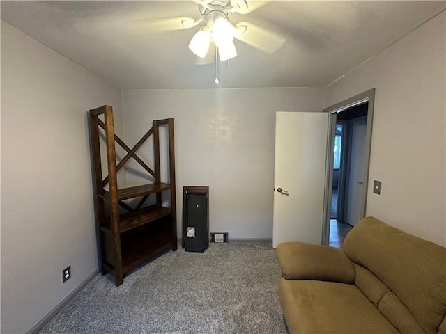 carpeted living room with ceiling fan