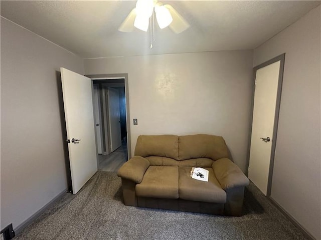 carpeted living room featuring ceiling fan