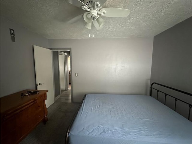 carpeted bedroom featuring ceiling fan and a textured ceiling