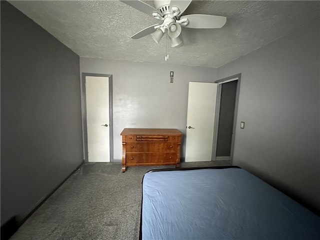 carpeted bedroom featuring ceiling fan and a textured ceiling