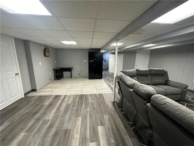 living room featuring hardwood / wood-style floors and a paneled ceiling