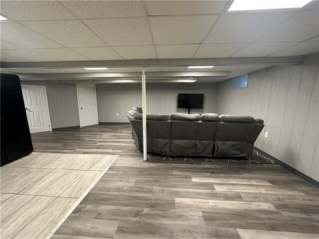 living room with a paneled ceiling and wood-type flooring