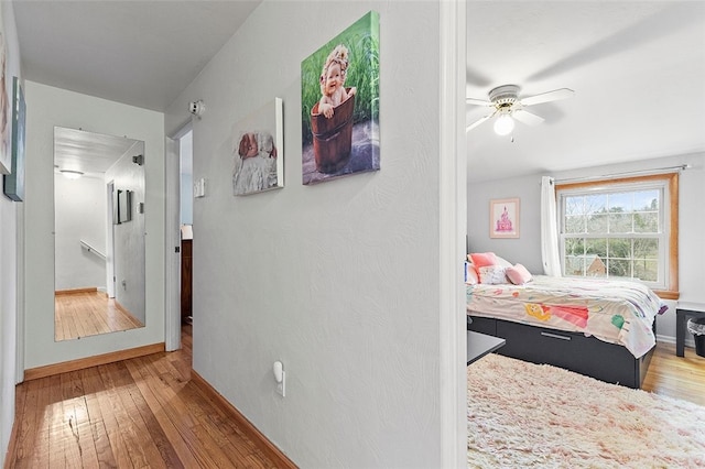 bedroom with ceiling fan and hardwood / wood-style floors