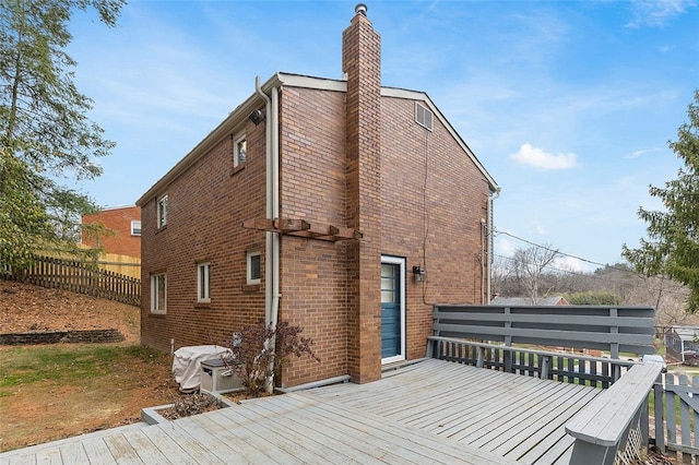 rear view of house with a wooden deck