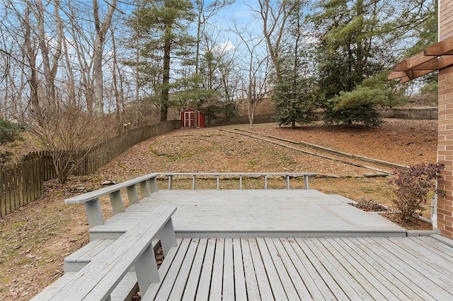 wooden terrace featuring a storage unit