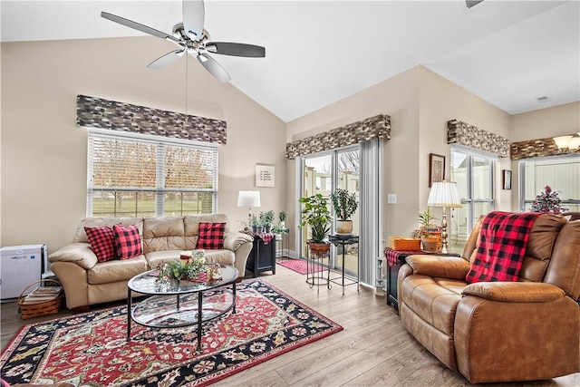 living room featuring light wood-type flooring, high vaulted ceiling, and ceiling fan