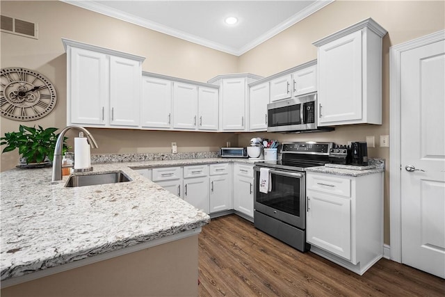 kitchen featuring sink, dark hardwood / wood-style floors, ornamental molding, white cabinetry, and stainless steel appliances