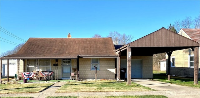 view of front of property with a front yard, a garage, a porch, and a carport