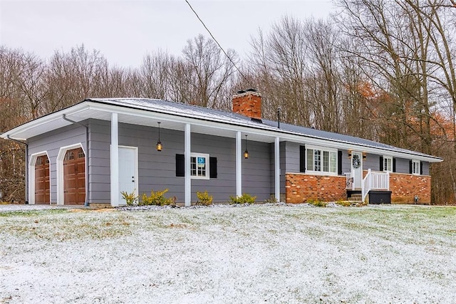 single story home featuring a porch and a garage