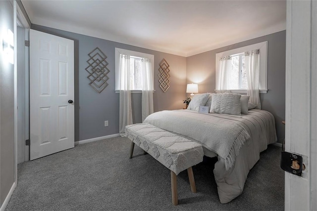 carpeted bedroom featuring multiple windows