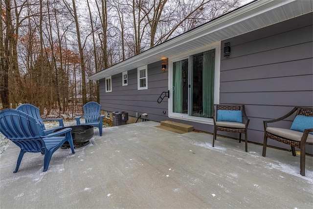 view of patio / terrace featuring a fire pit and central air condition unit