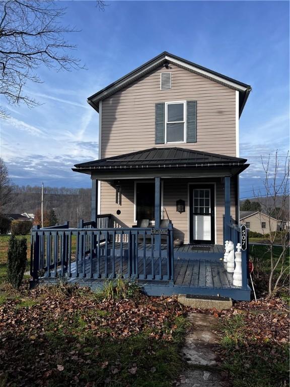 rear view of property with covered porch