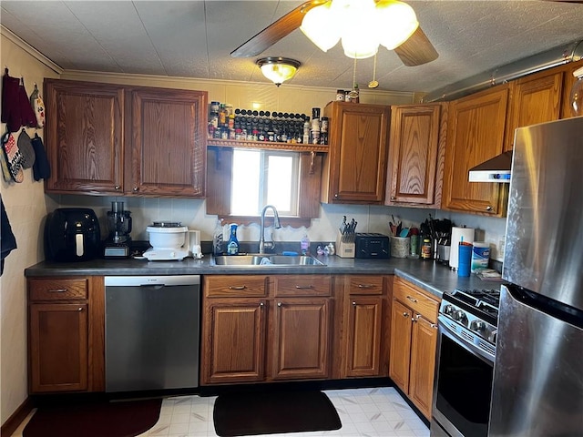 kitchen featuring ceiling fan, sink, extractor fan, appliances with stainless steel finishes, and ornamental molding