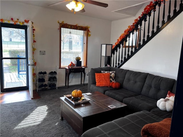 carpeted living room featuring ceiling fan and ornamental molding