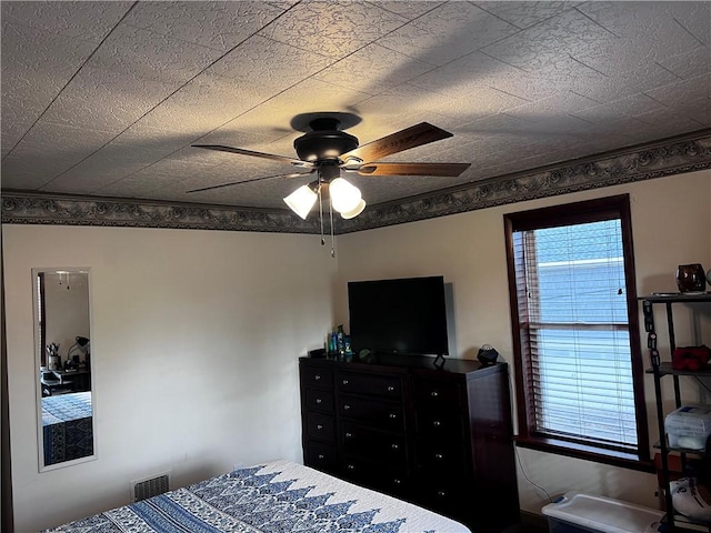 bedroom featuring ceiling fan and crown molding