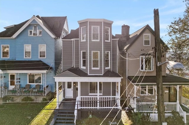 view of front of home featuring covered porch and a front lawn