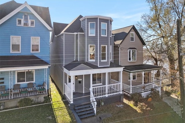 view of front of home with covered porch and a front lawn