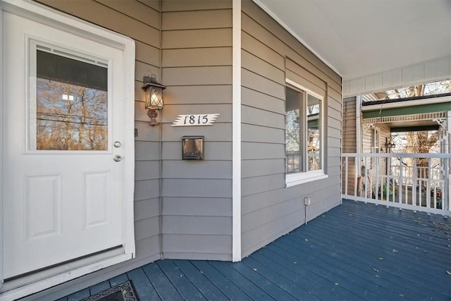 view of exterior entry with a porch