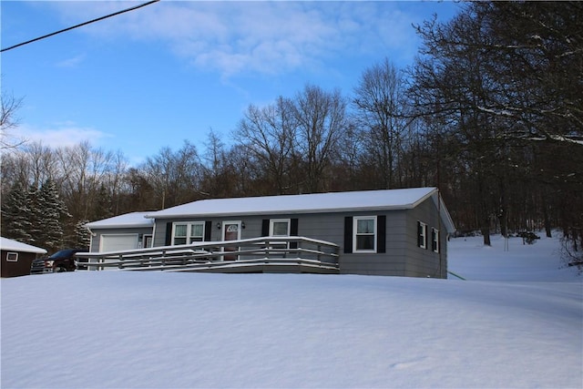 view of front facade with a garage and a wooden deck