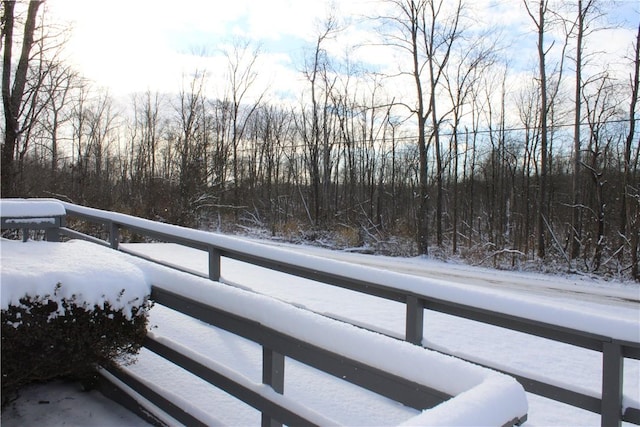 view of snow covered back of property