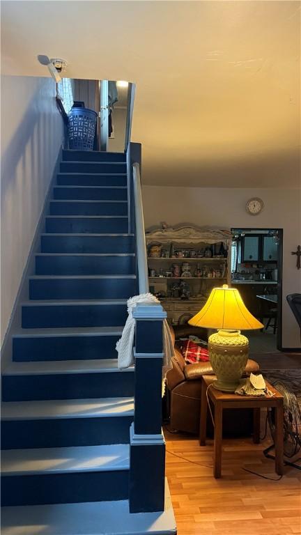 stairs featuring wood-type flooring